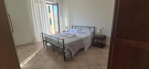 a bedroom with a bed and a table with towels on it at EremAre Viareggio Casa Vacanza in Viareggio