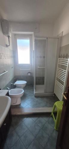 a bathroom with a shower and a toilet and a sink at EremAre Viareggio Casa Vacanza in Viareggio