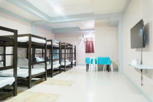 a room with a bunch of bunk beds at Jared Suites in Upper Digos