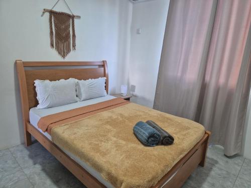 a bed with a bag sitting on top of it at Skyview Apartment- Rooftop Penthouse with Sunset & Sea Views in Flic-en-Flac