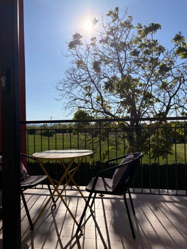a patio with a table and two chairs on a balcony at Sala dell Estate Guest House in Secchia