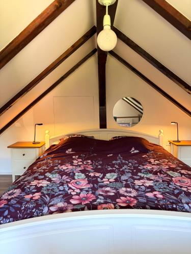 a bedroom with a large bed with a floral bedspread at Chalet Le Klet in Krapinske Toplice