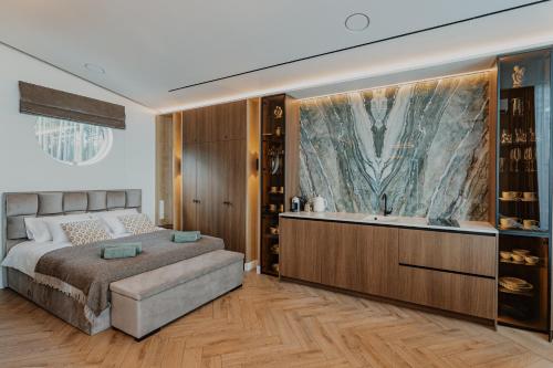 a bedroom with a large bed and a bath tub at Lavyso perlai, 5-6 nameliai in lavysas