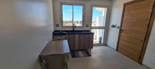 a kitchen with a counter and a sink and a window at Dar Lebharr Studio in Kelibia