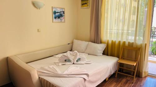 a bed with towels on it in a room at AMADEUS I Studio 25 Sunny Beach in Sunny Beach