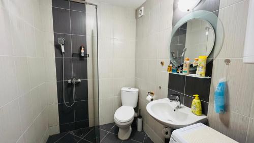 a bathroom with a shower and a toilet and a sink at AMADEUS I Studio 25 Sunny Beach in Sunny Beach