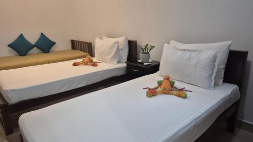 two beds with stuffed animals sitting on top of them at 2 Bed Apartment in Colombo 3 in Colombo