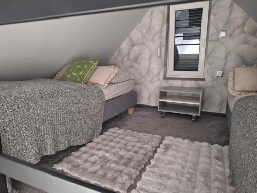 a living room with a bed and a mirror at Domek Za Wyspą 1 in Chmielów
