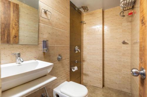 a bathroom with a sink and a toilet and a shower at Hotel Suites Inn in Mumbai