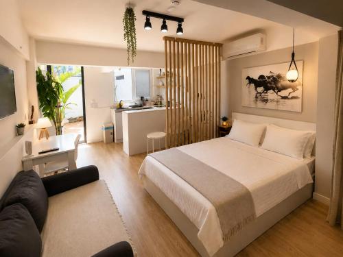 a bedroom with a bed and a living room at Alex Suites Lara in Antalya