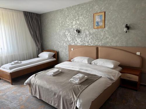 a hotel room with two beds with towels on them at Rotonde View in Predeal