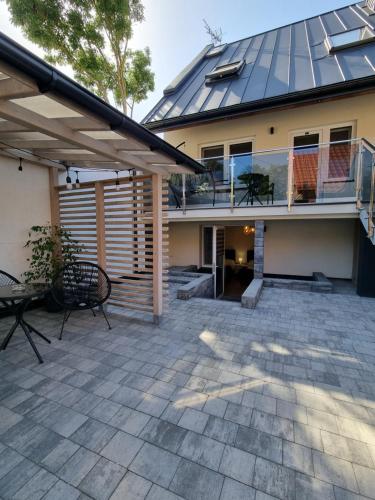 a patio with a house with a solar roof at Biały Port in Rajgród