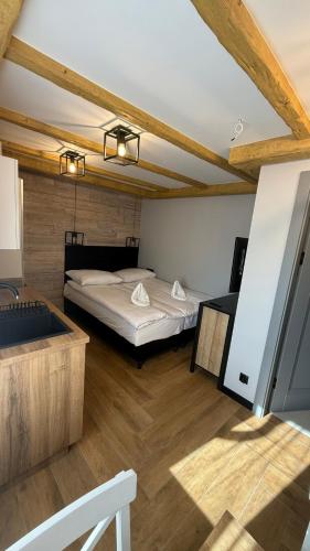a bedroom with a bed in a room with wooden ceilings at Dom przy Wangu Karpacz in Karpacz