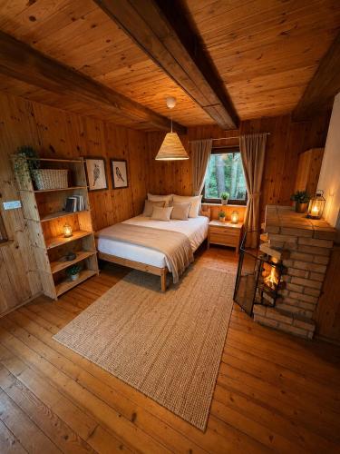 a bedroom with a bed in a wooden room at Wiśniowa Chata in Rentyny