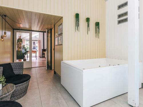 a living room with a white tub in a room at 4 star holiday home in Væggerløse in Bøtø By