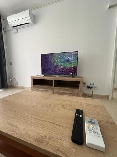 a living room with a flat screen tv on a table at Cozy Apartment with Pool at 5 Min to Beach in Salou