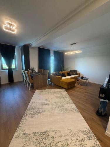 a large living room with a couch and a table at L&D Apartments in Urseni