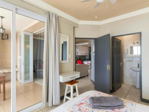 a bedroom with a bed and a bathroom at The Sunset Villas in Velddrif