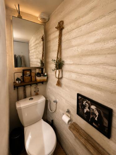 a bathroom with a white toilet and a mirror at Narkis - A Boutique Stay in the Heart of Jerusalem in Jerusalem