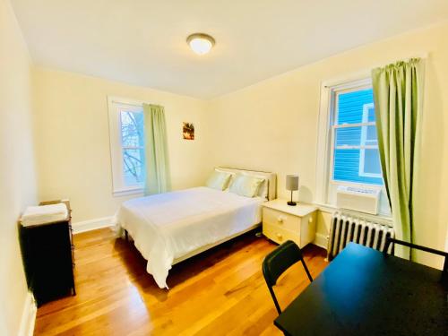 a bedroom with a bed and a table in it at CaneView Properties - 3 in Irvington
