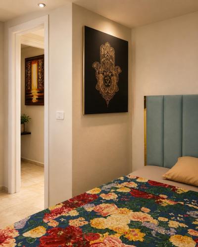 a bedroom with a bed and a painting on the wall at Villa Bleu Horizon in El Haouach