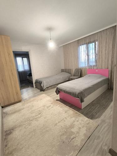 a large room with two beds and a couch at Ashtarak home in Ashtarak