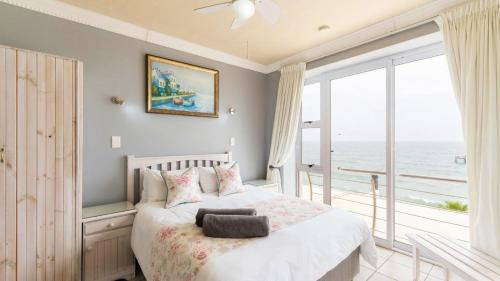 a bedroom with a bed with a view of the ocean at The Sunset Villas in Velddrif