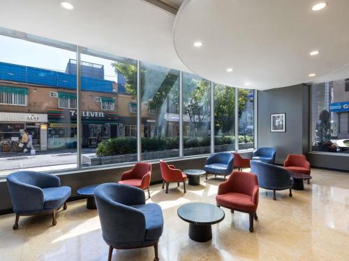 a waiting room with chairs and tables and windows at ibis Ambassador Seoul Insadong-Newly renovated in 2025 in Seoul