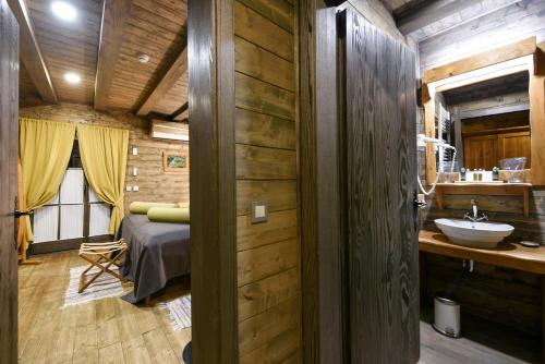 a bathroom with a bed and a sink in a room at Lakeside Hotel Plitvice in Plitvička Jezera