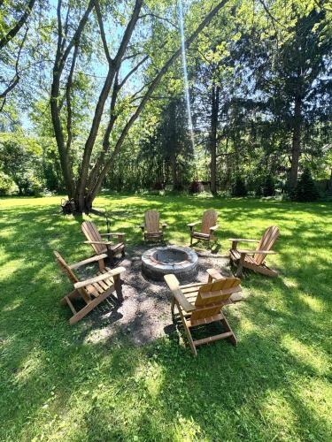 a group of chairs and a fire pit in a yard at The Borderland in Michigan City
