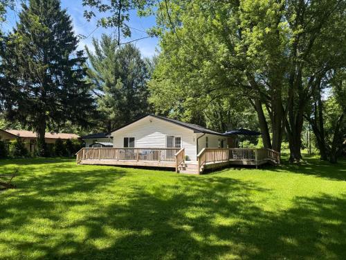 a house with a large yard with a deck at The Borderland in Michigan City