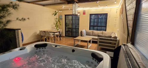 a bath tub in a room with a couch and a table at Bella Vista 234 in Lajita