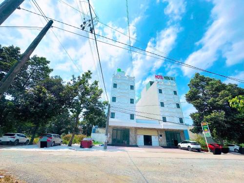 a white building with a sign on top of it at Hotel PHƯƠNG MAI 2 in Bến Lức