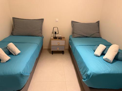 two beds sitting next to each other in a room at Apartment Odysea in Platanias