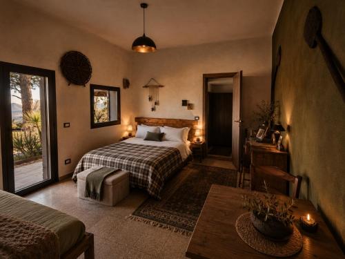 a hotel room with a bed and a table at Etna Country Home in Nicolosi