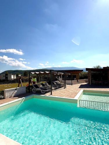 a large swimming pool next to a patio at Villa Leah in Bihać