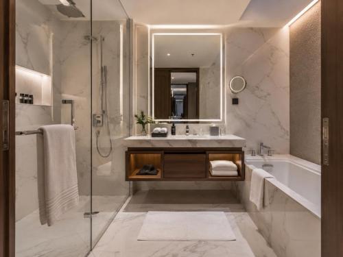 a bathroom with a tub and a sink and a shower at Hotel Preeti Residency Delhi in New Delhi