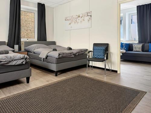 a bedroom with a bed and a chair and a couch at Gruppenloft Stuttgart Kicker & 14 Gäste in Stuttgart