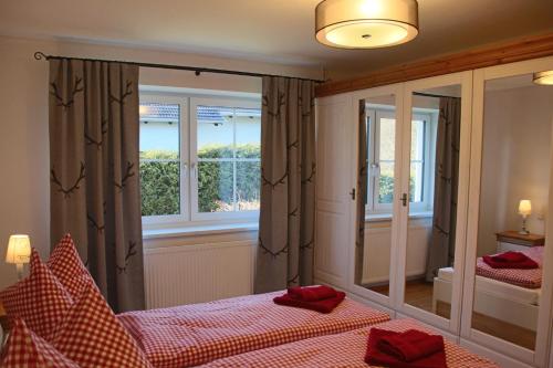 a bedroom with two beds and a large mirror at Villa Hilde in Oy-Mittelberg
