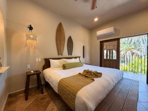 a bedroom with a large bed and a large window at Hotel 1697 Loreto in Loreto