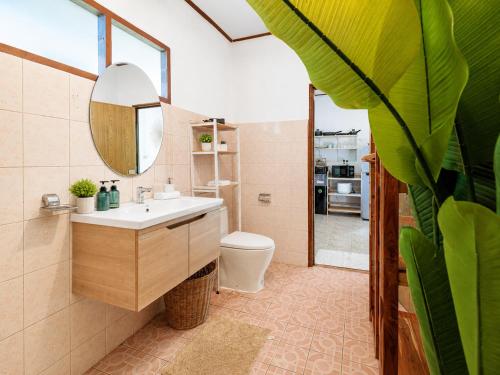 a bathroom with a sink and a toilet and a mirror at Amsterdam House - Hin Kong - Double King Bed - 4K SmartTV in Wok Tum