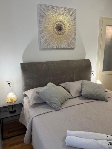 a bed in a bedroom with a mirror on the wall at Stella in Šibenik