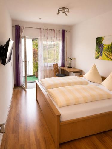 a bedroom with a large bed in front of a window at Bed and Breakfast - Rheingauer Hof in Oestrich-Winkel