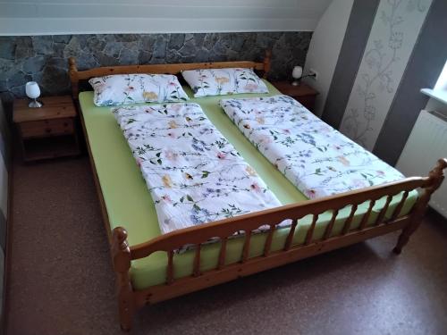 a bed with two pillows on it in a bedroom at Eneri in Südbrookmerland