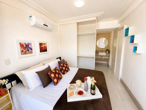 a bedroom with a bed with a tray of food on it at Apto. Palm Beach, 300M Beach Park in Aquiraz