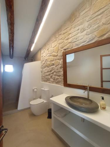 a bathroom with a sink and a toilet at casa LHort in Benisili