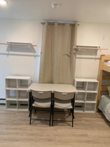 a table and a chair in a bedroom at Pond Studio Apartments in Seward