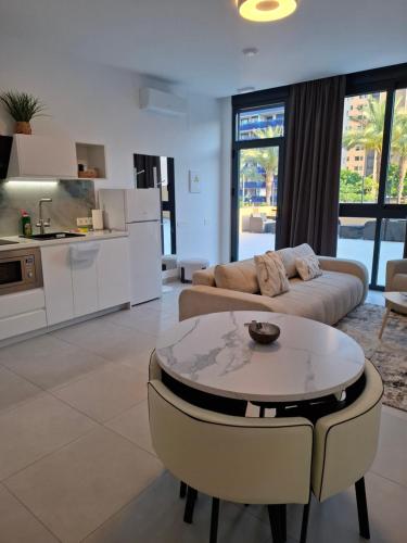 a living room with a couch and a table at Costa Royal Resort in Villajoyosa