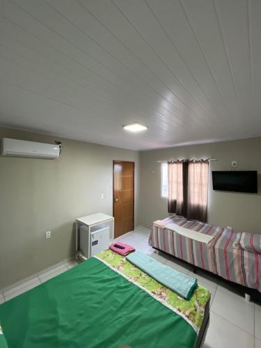 a bedroom with two beds in a room at Pousada do Gil in Iguatu