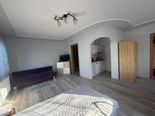 a bedroom with a bed and a couch in it at W zieleni in Polanica-Zdrój